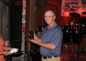 Lucky winner Tim Stephens showed the Madagascar Emerald from the Cupcake Raffle.  at Schooner Wharf Bar.